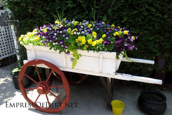 Creative DIY garden containers -  repurposed wooden wagon with flowers