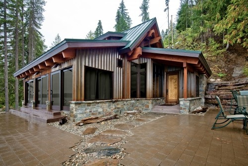 very interesting home that has open tresses...the floor is black polished concrete inside. Love the front door and the side doors.