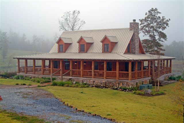 Log cabin with a tin roof and a wrap around porch. This is my dream porch!