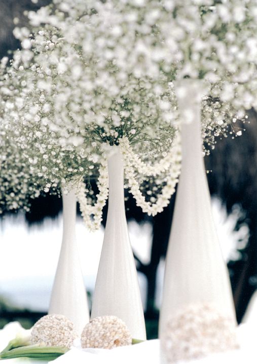 Baby's Breath in wine bottles that have been painted white & rolled in Epson salt. Beautiful and cheap!