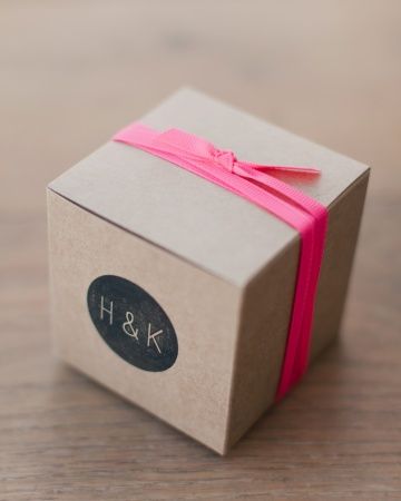 Kraft boxes bundled with hot pink ribbon and rubber stamped with a custom design