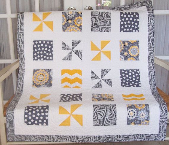 Baby quilt in yellows, grays, and cream square and pinwheel block. via Etsy