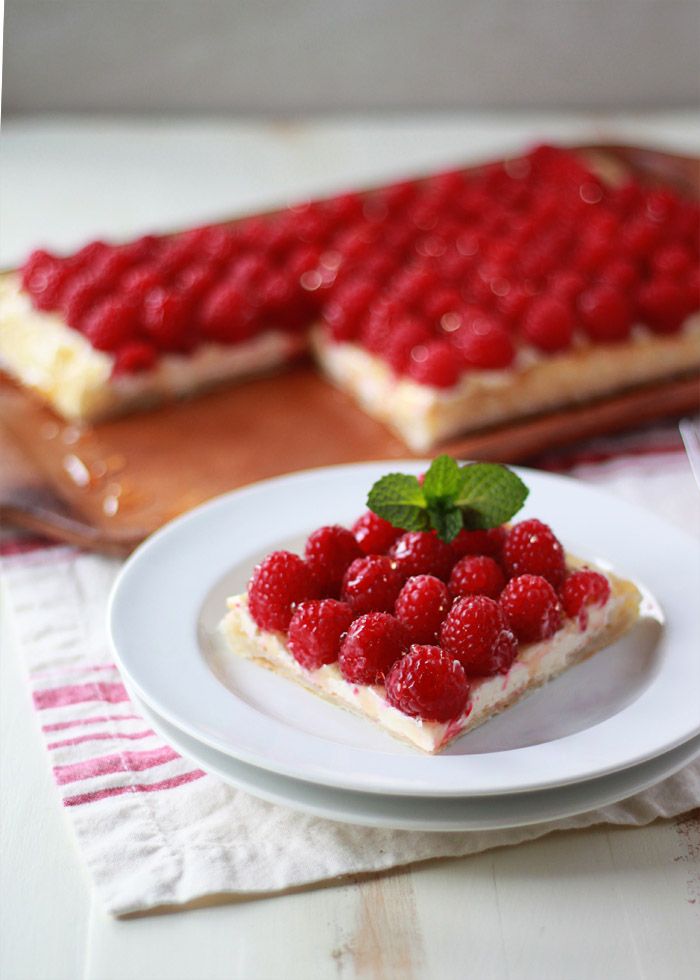 Fresh Raspberry Cream Cheese Puff Pastry Tart - Lush raspberries atop a fluffy lemon-vanilla cream cheese filling and a buttery golden puff pastry crust. This easy tart is sure to impress the guests at the holiday table. Only you need to know how easy it 