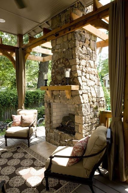 covered patio with stone fireplace