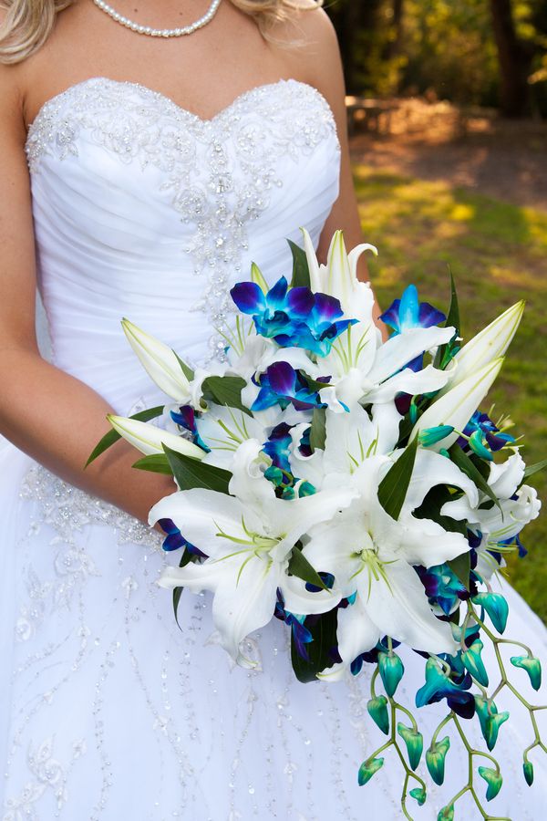 Bouquet of beautiful blue orchids and white lilies. I want it! I think this is the bouquet I want for sure. I amy add other flowers in it but I actually like this one a lot. The orchids are very colorful so I have a lot to work with here as far as matchin