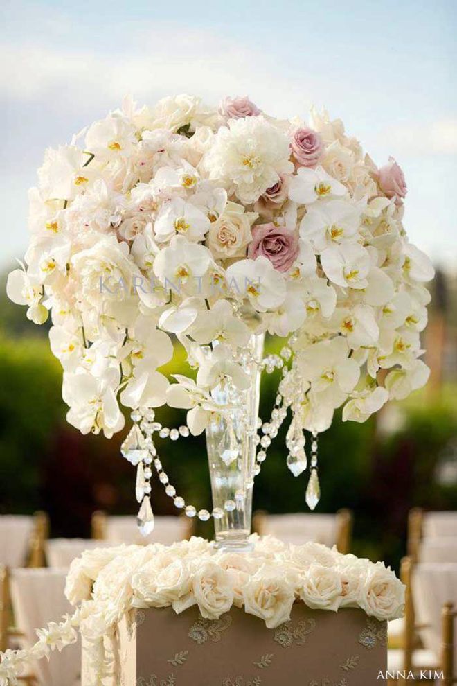 Want a spectacular wedding ceremony entrance? Use tall centerpieces on sturdy pillars to line the wedding aisle. After the ceremony, your florist can transport the centerpieces to your reception and place them on guest tables. Dual-use flower arrangements