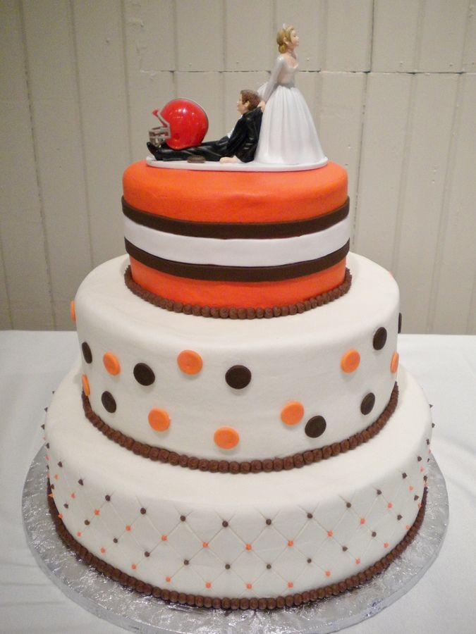Not a Football, but this is to cute to not share! The bride and groom were huge Cleveland Brown's football fans and had their fall wedding theme to include Brown's football!  Buttercream iced tiers with fondant circles and stripes.