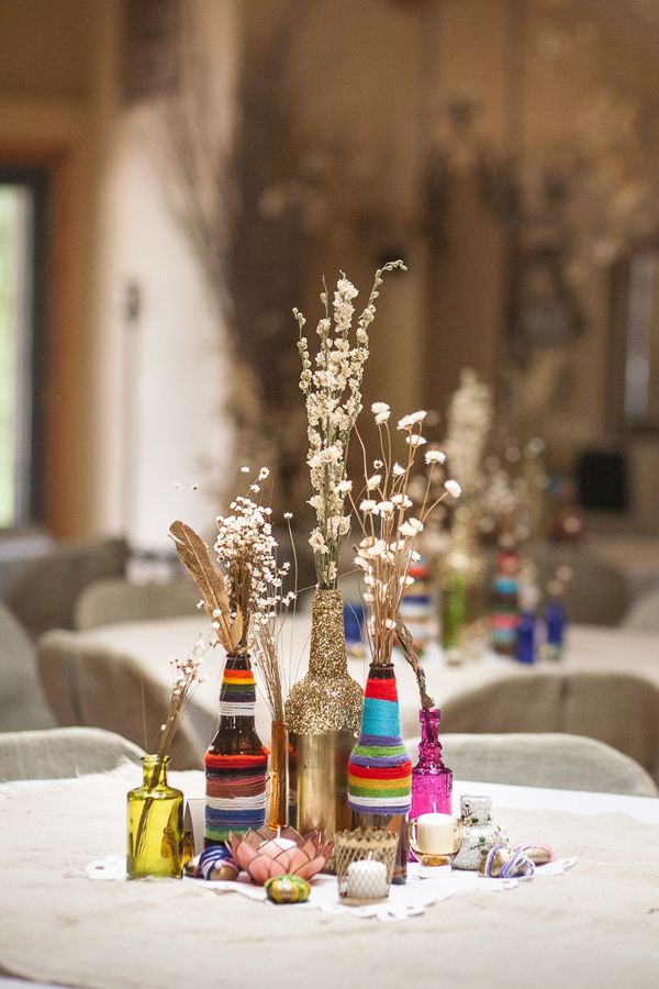 Wrapped bottles to double as centerpieces... Not with yarn, but paint and glitter on wine bottles could make a great and inexpensive centerpiece!!