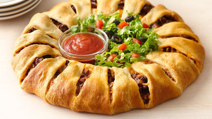 This taco-filled crescent ring is the perfect meal for Taco Night!  Dress it up with fresh shredded lettuce, chopped tomatoes and taco sauce for a fun twist on tacos!