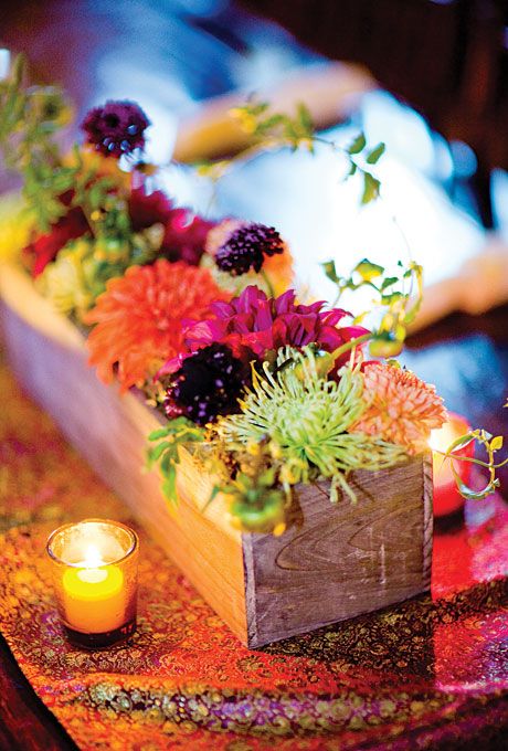 The centerpieces were wooden boxes filled with vibrant chrysanthemums and dahlias. All wedding flowers were by Peony & Plum Floral Design.