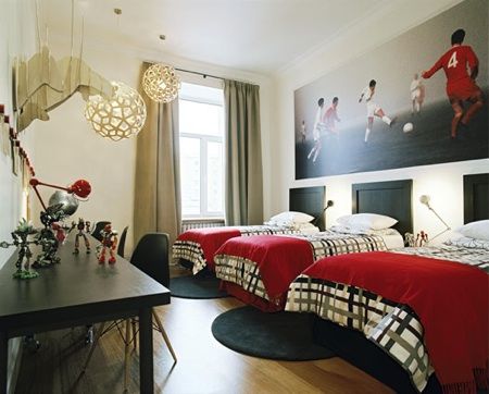 love this bedroom for 3 boys // enlarged soccer photo // headboards // desk for 3 across from beds // bedding + red blankets // task lighting
