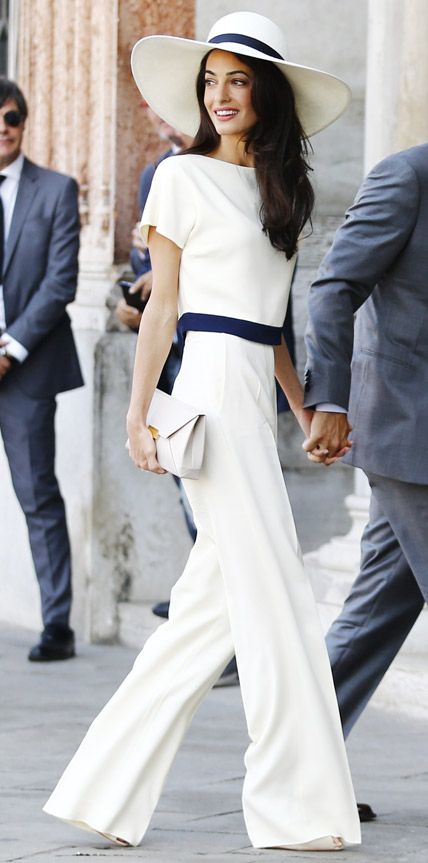 To wrap up her wedding festivities with a civil ceremony at Venice’s Municipal Building, the new Mrs. Clooney stunned in a chic ivory-and-navy top (that matched her wide-brimmed hat) and ivory pants with a neutral clutch. Amal Clooney's Most Stylish L