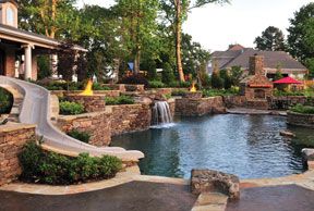 Backyard with a Giant Pool, Hidden Cave, Firepits, Slide, Pool House & More