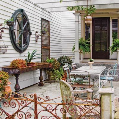 Outdoor Rooms On a Budget | patio with pergola, mirror, garden gate and planters