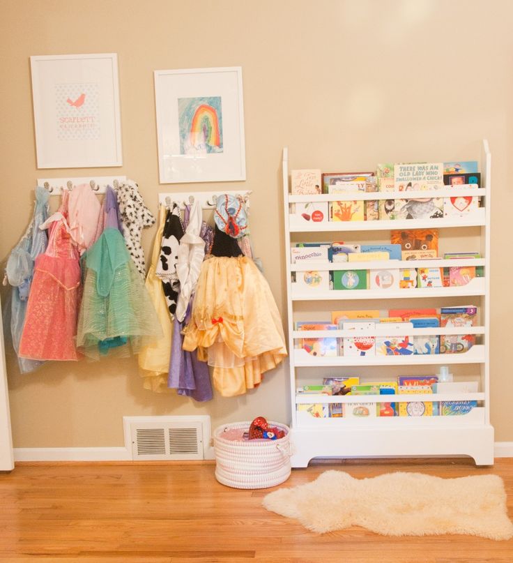 hang dress up dresses on the wall to keep them from getting torn up as well as adding decor to a room