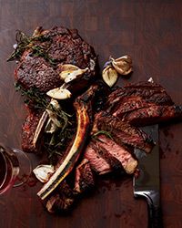 This steak is based on a recipe from Alain Ducasse. Halfway through cooking, these bone-in rib eyes are basted with a mixture of butter, thyme and garlic, so they're crusty outside and richly flavored.  Slideshow: More Incredible Steak Dishes