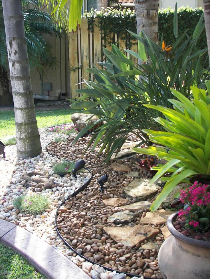 Rock Garden Landscape, great idea, with plants in pots in rocks the dogs might not dig them up...