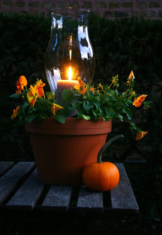 great for your porch or patio! smaller pot in the middle filled with pea gravel to hold hurricane & candle...soil filled in  around that pot & and then plant your favorite flowers!