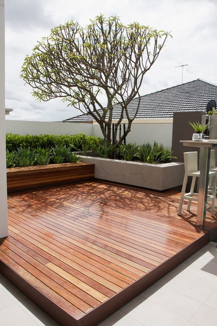 This looks as though it should be a roof terrace.  This decked patio is by Tim Davies Landscaping