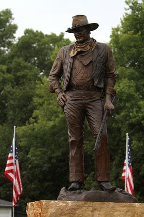 A statue of John Wayne, donated by his children, stands on the site in Winterset, Iowa, where a museum to the town's favorite son is planned.