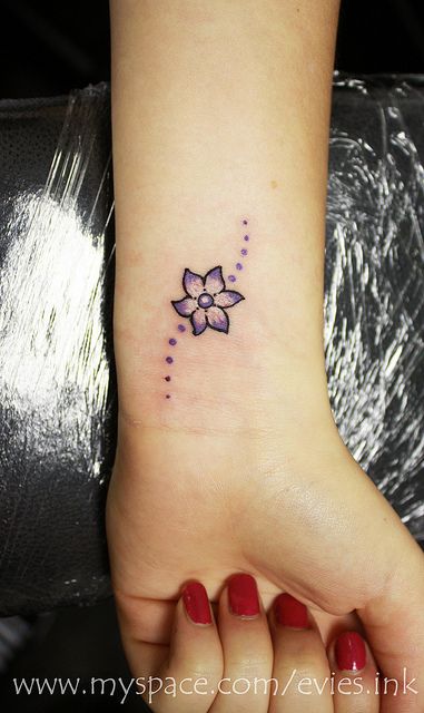 Tiny flower tattoo on wrist.  Pretty.