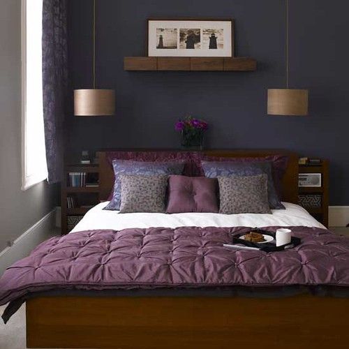 Small purple and gray bedroom, hanging lighting, dark wood furniture, shelving